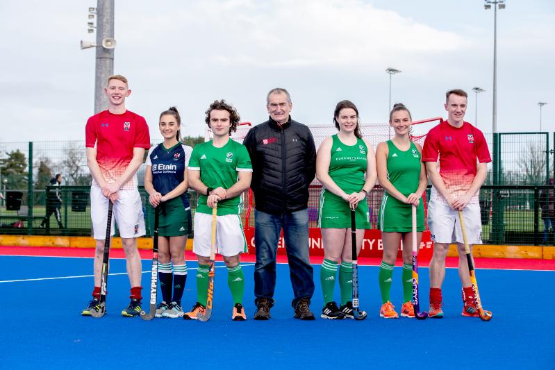 Hockey players line up on the pitch with UK and Ireland jerseys