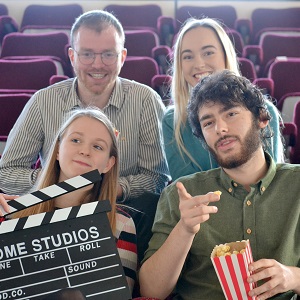 Students watch a movie with popcorn and laughter