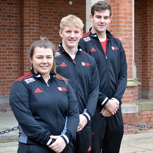 Rugby players stand in procession