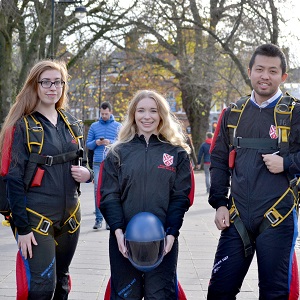 Skydiving club stand together in full suits and helmets