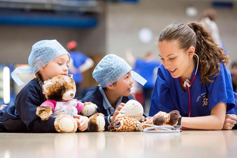 2 kids and a student at the Teddy Bear Hospital