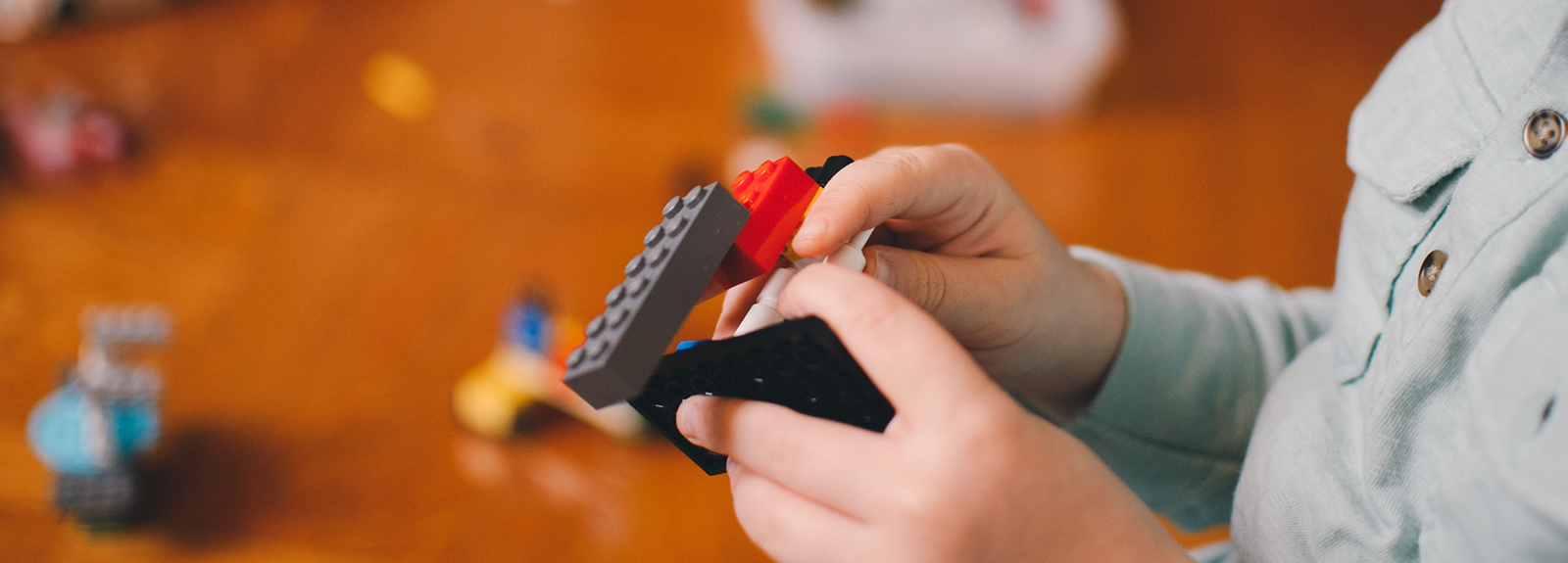 Child playing with Lego