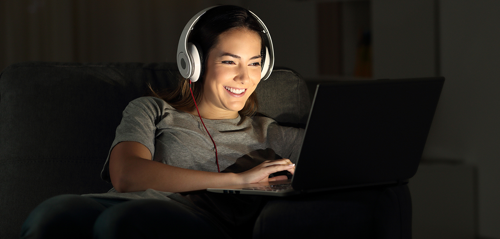 Woman with headphones and a laptop