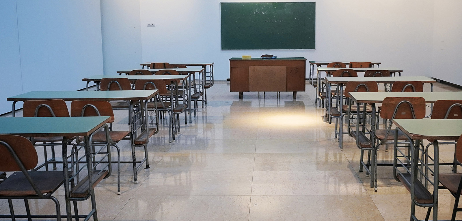 Empty desks in an empty classroom