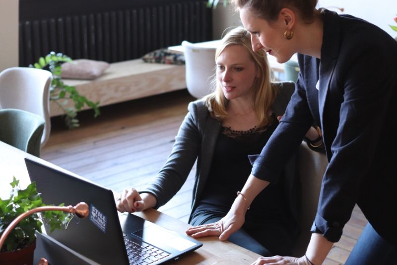 Two women looking at a computer screen