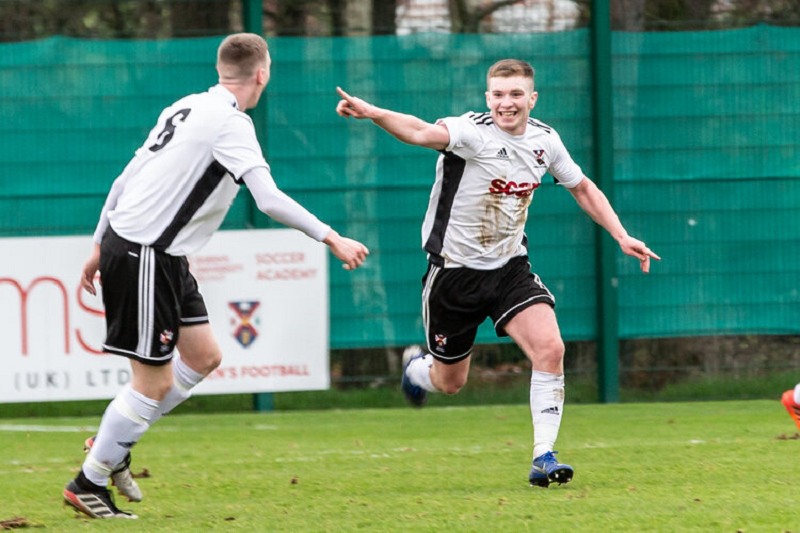 Football player signals his teammate as he passes the ball