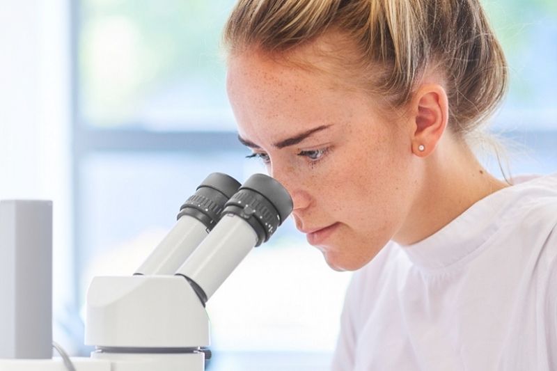 Student looking in microscope