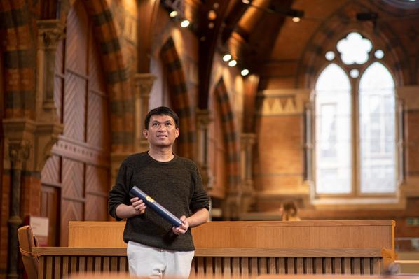 Sukirman with a scroll holder in the graduate school