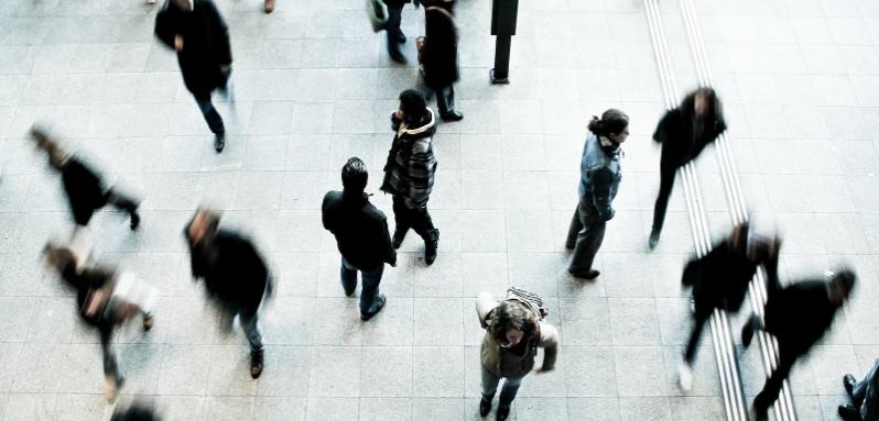 aerial view of blurred people on grey paved street