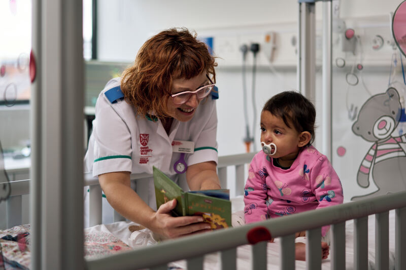 Nursing student with female baby in hospital style setting