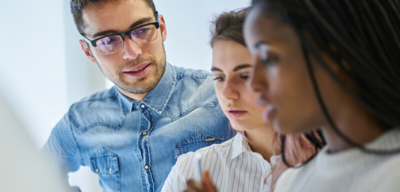 Three people analysing data