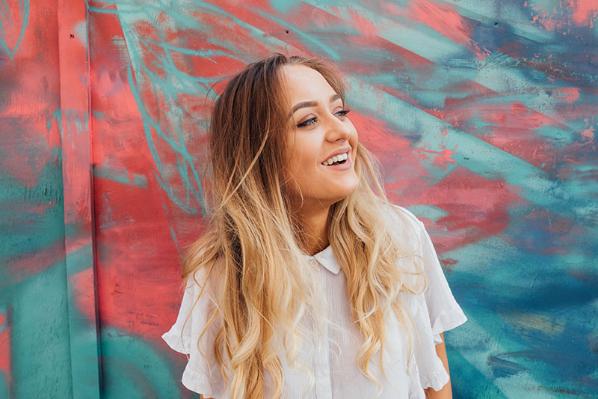 Blond student at graffitti wall