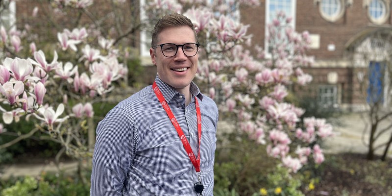 Portrait of Raymond Miller in front of blossoming cherry tree