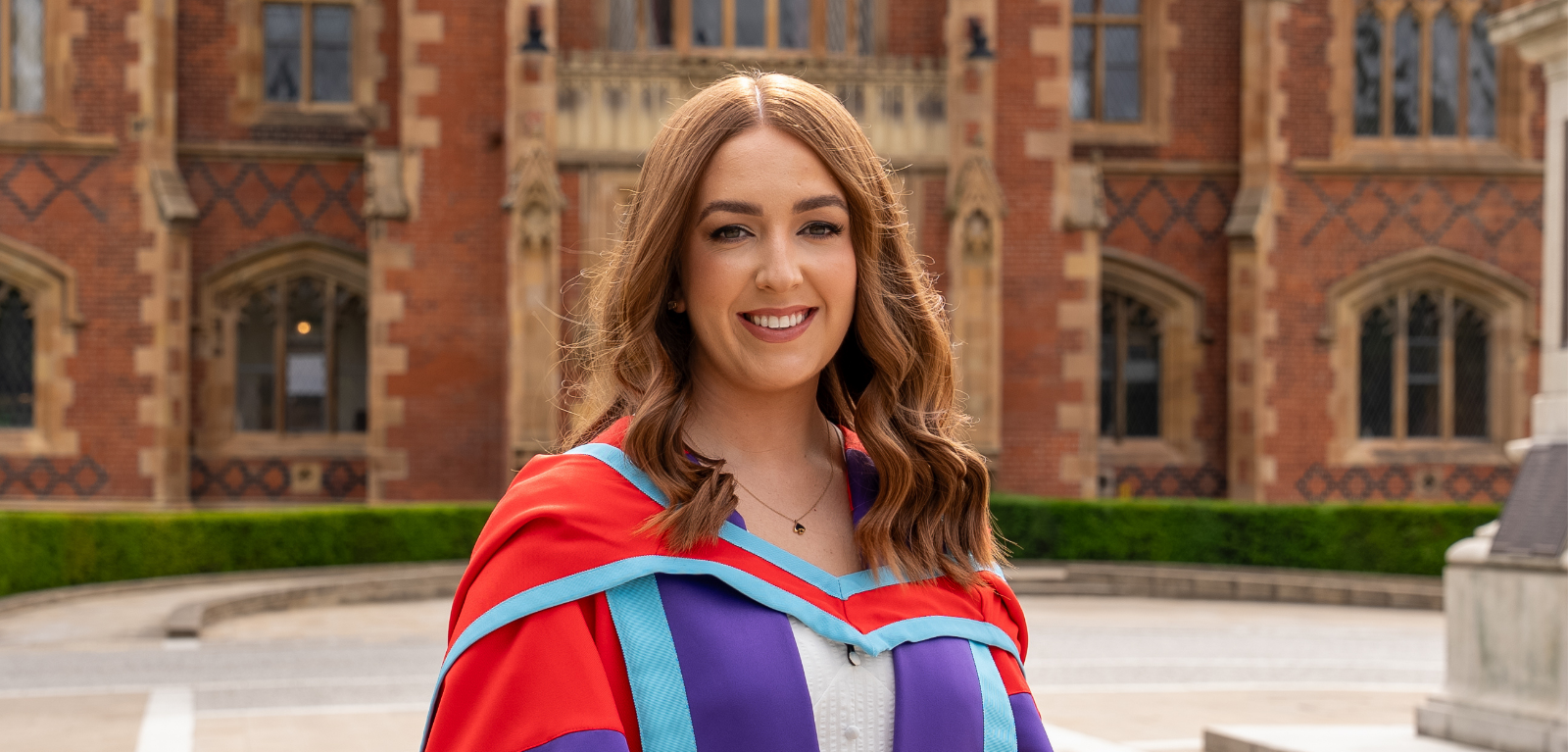 Dr Steph Craig at Summer Grad 2025 outside Lanyon