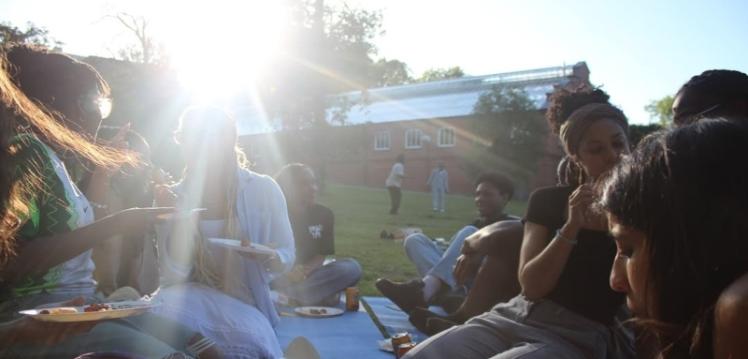 Members of the African Caribbean Society sitting together in Botanic Gardens