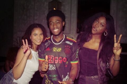 Two female and one male member of the African Caribbean Society at Queen's