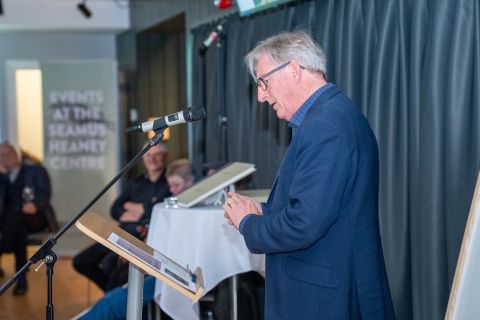 man standing at podium speaking