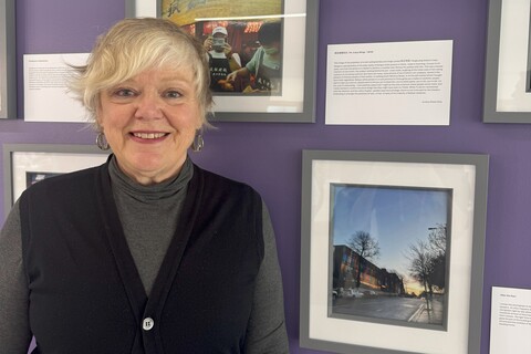 Lesley-Anne Evans stands in front of her photo submission for the AEL photography competition