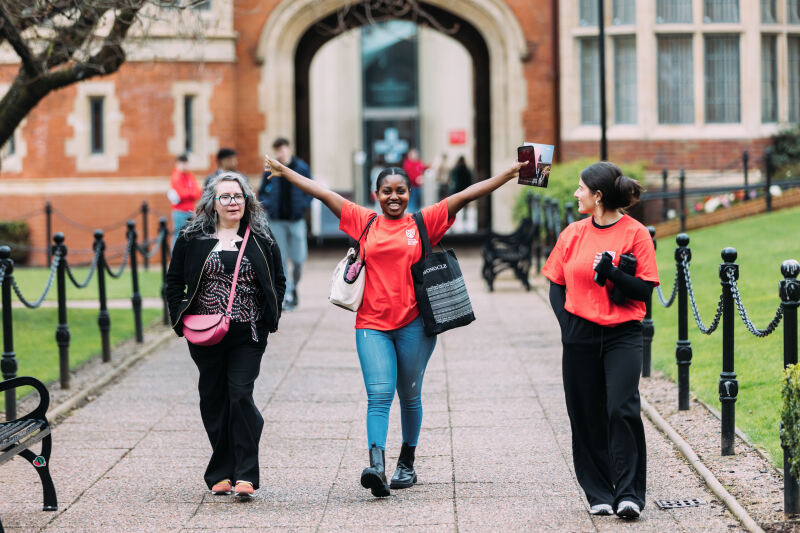 Student ambassadors and parent walk through Quad
