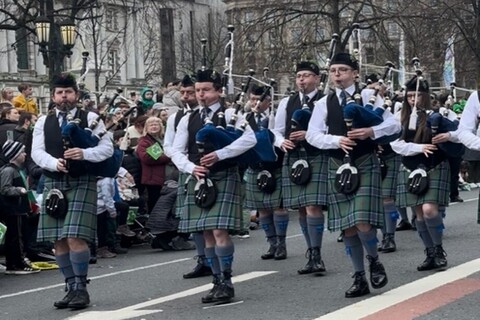 Group playing bagpipes at St Patrick's Day parade in Belfast
