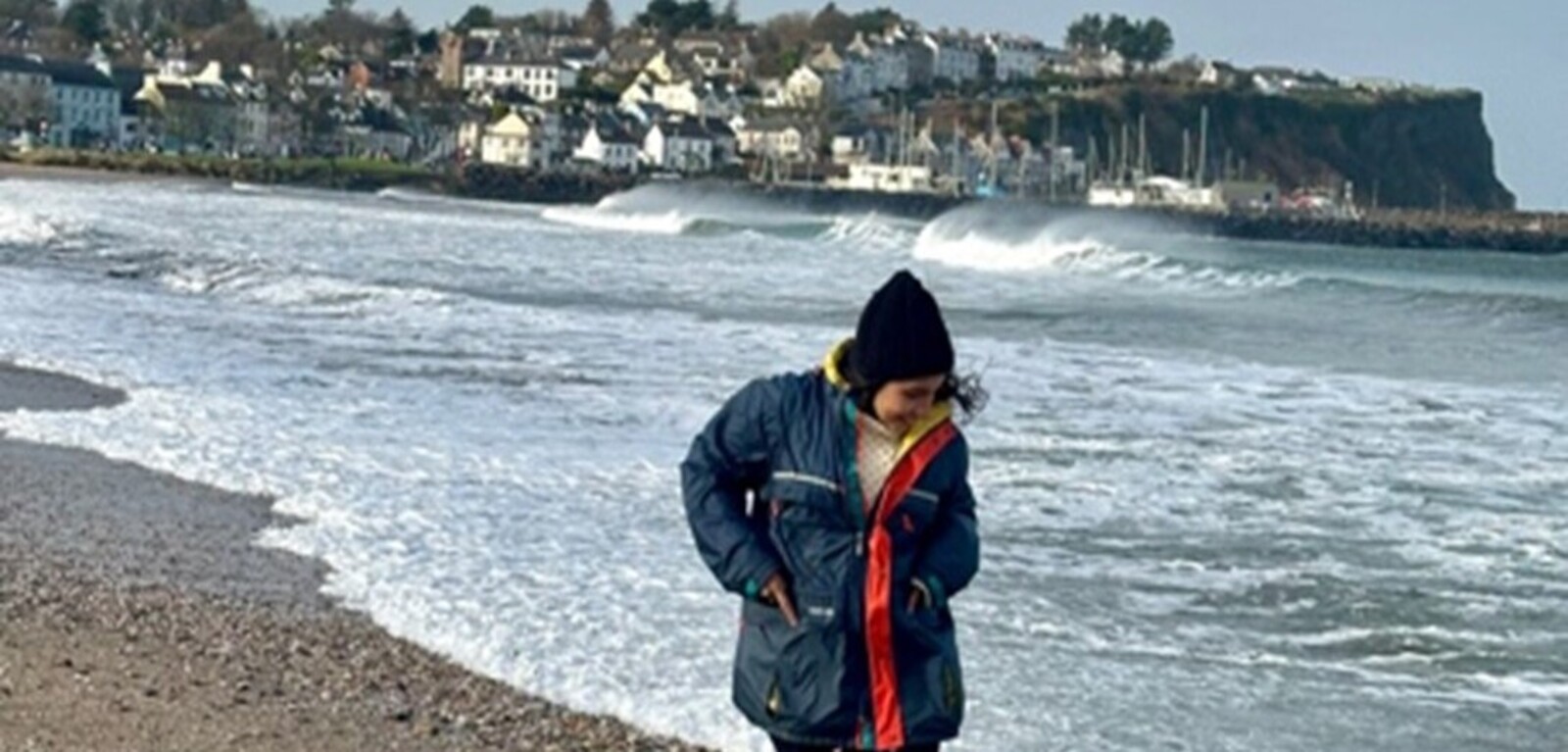 Student walking along Ballycastle Beach