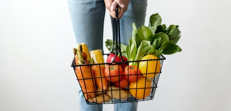 Woman holding basket of groceries