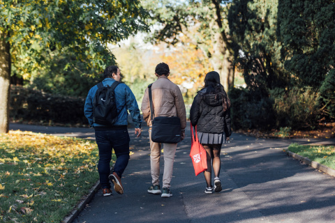 Three students walking through Botanic Gardens