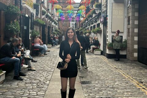 Student Brittany under umbrella light display in Cathedral Quarter