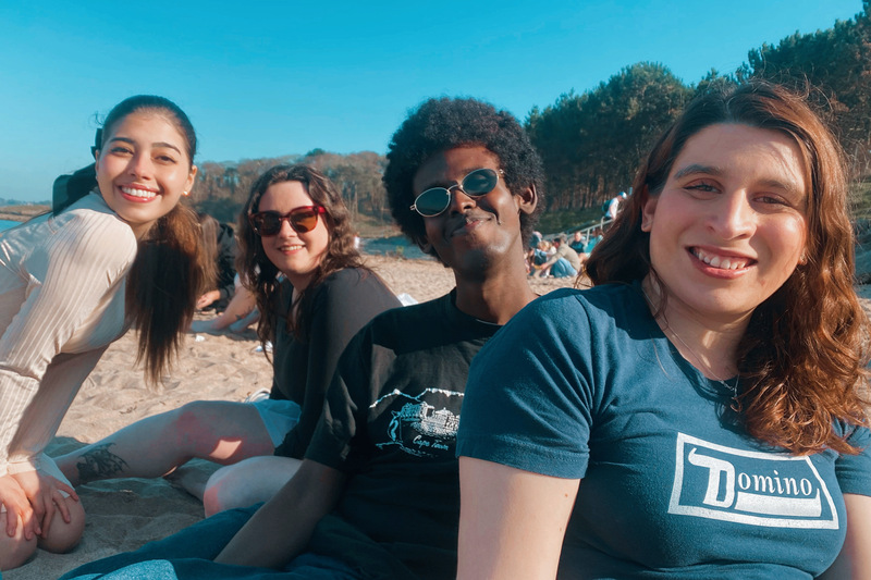 Student Brittany with three friends at the beach