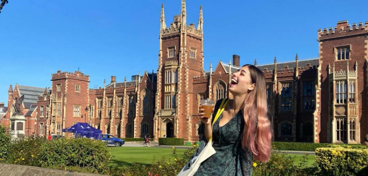 Student Brittany laughing in front of Lanyon building