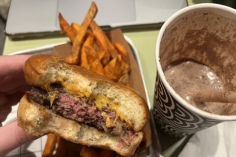 Half eaten burger from Bunsen with fries and milkshake