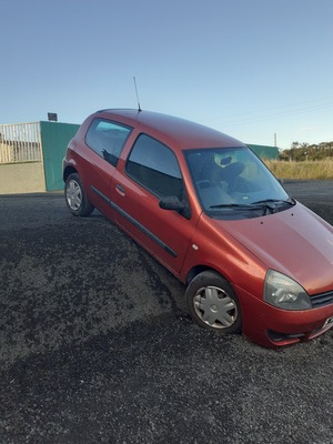Red car in ditch
