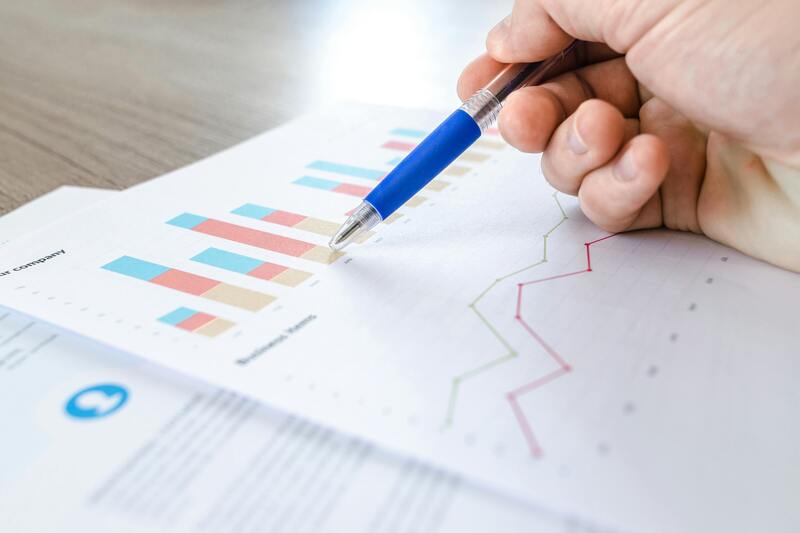 Person looking at chart and data with pen