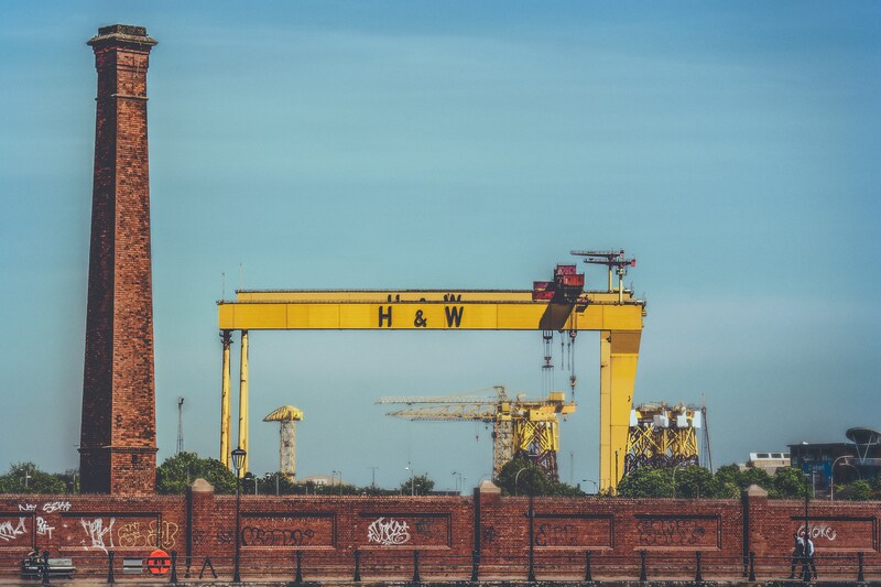 Harland and Wolff cranes behind brick wall