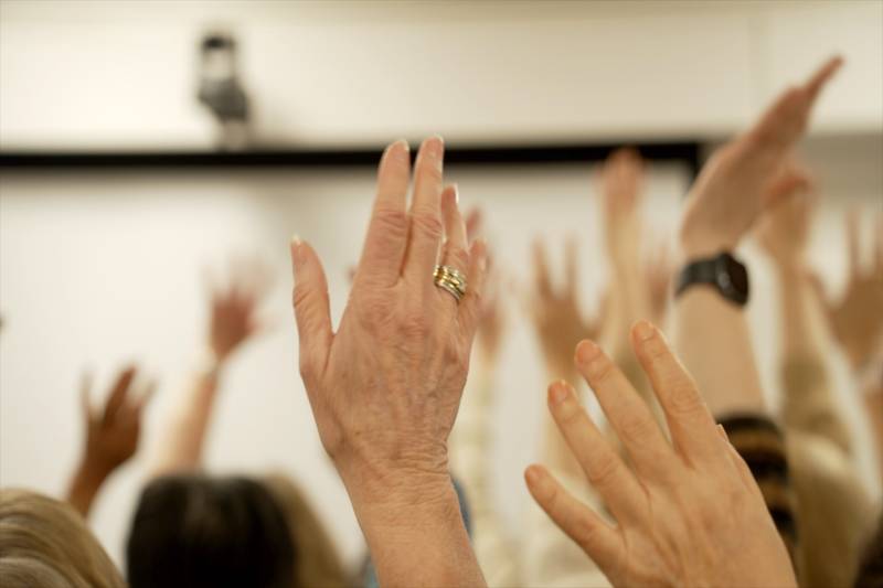 hands waving in the air