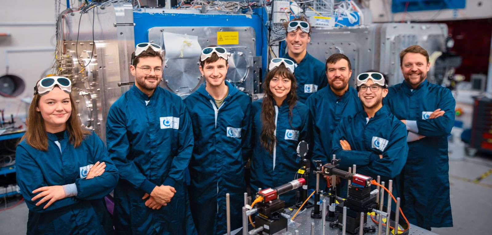 Some members of the experimental team in the Gemini laser target area. In the background is the Gemini target chamber.