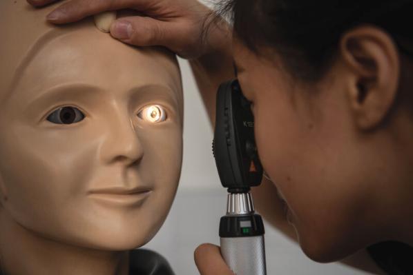 Researcher inspecting dummy eye at InterSim Centre, MBC
