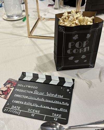 Popcorn and film slate on table at film society formal