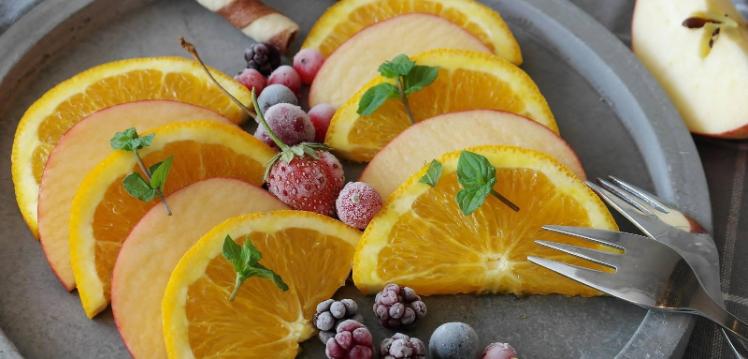 oranges and berries on a plate