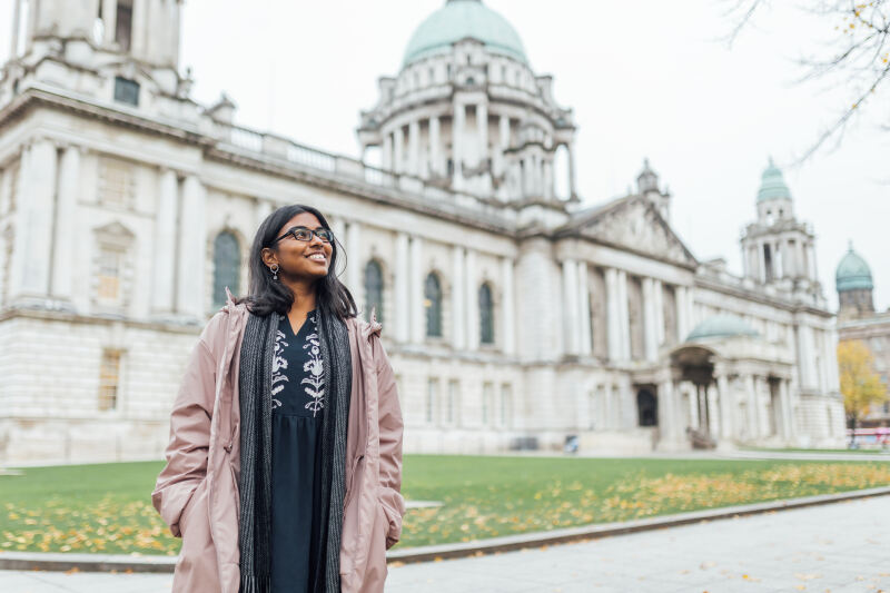 Student Florence stands in front of Belfast city hall