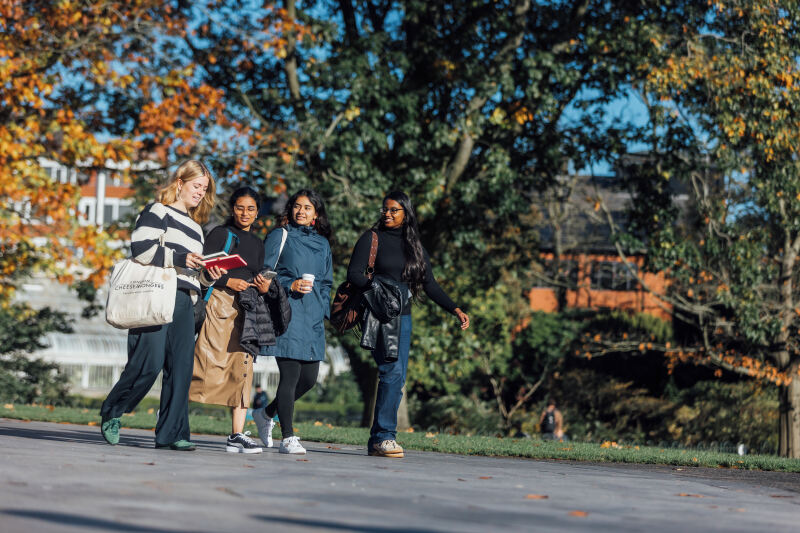 Four female students walking through Botanic Gardens