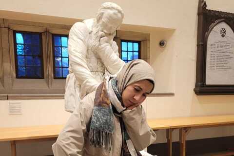 Student posing in front of Galileo statue