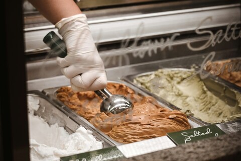 Person scooping gelato