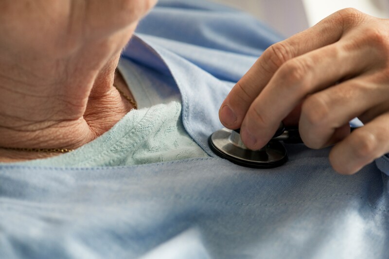 Older person getting checked by doctor with stethoscope