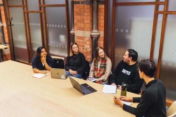 Group of PG students in group study room in the Grad School