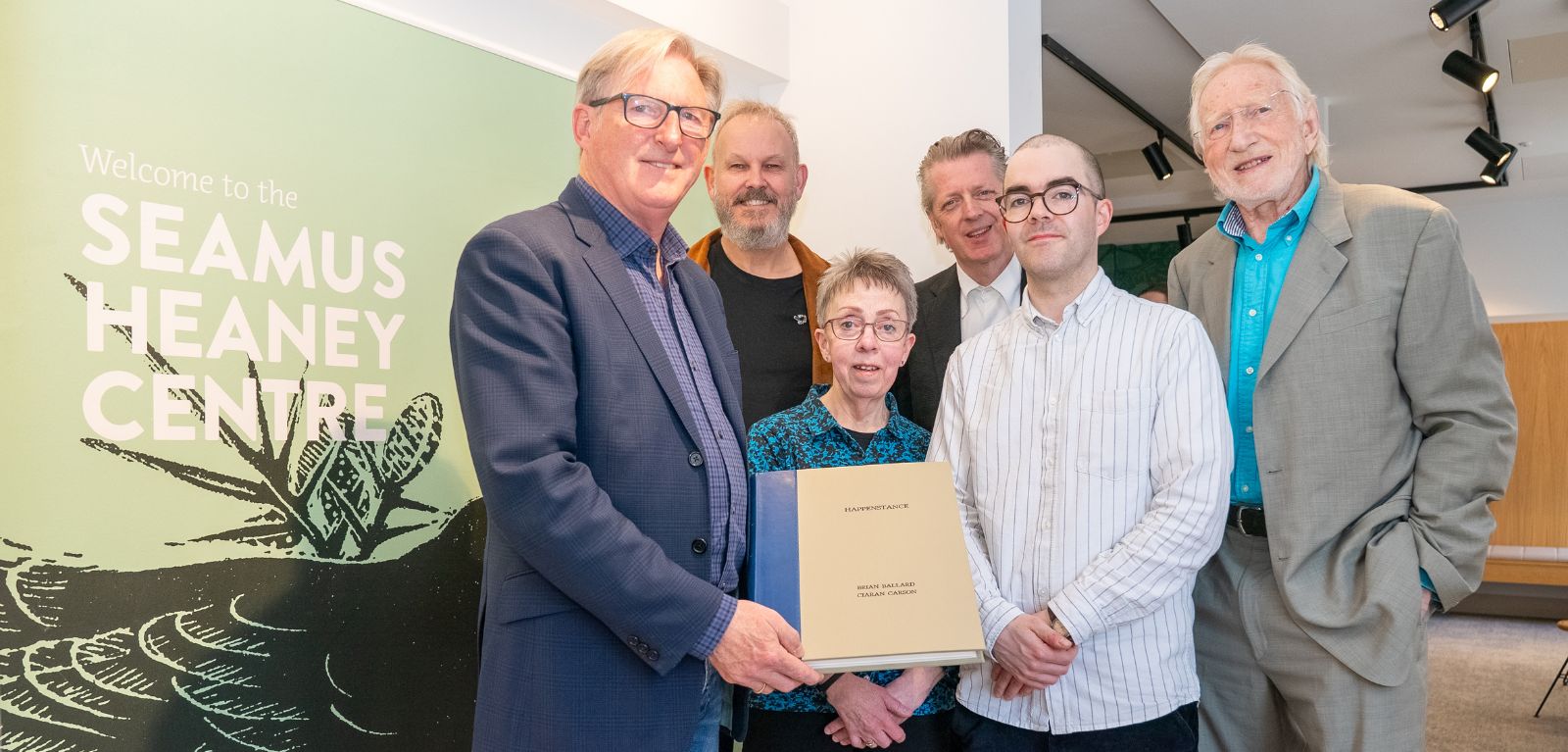 People standing holding a book