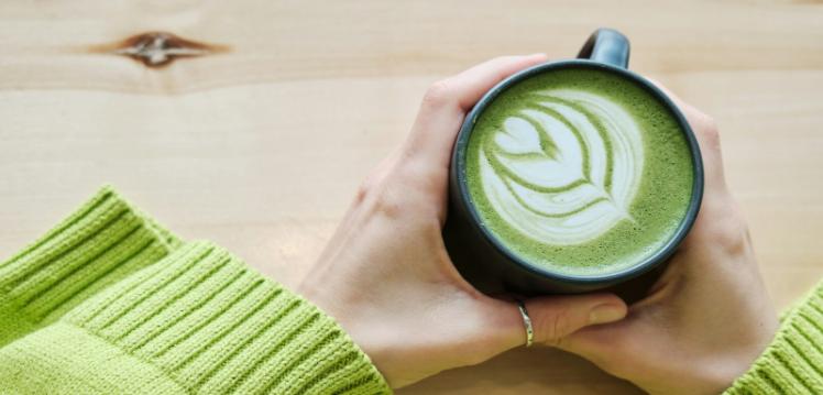 Person holding cup of matcha in their hands