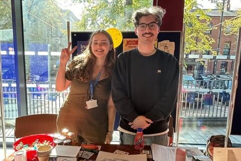 Two members of the Inclusion Society at a stall at Freshers Fair