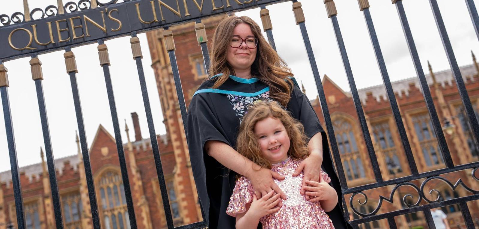 Graduate Jamie-Lee Beggs with daughter Freya outside Queen's gates