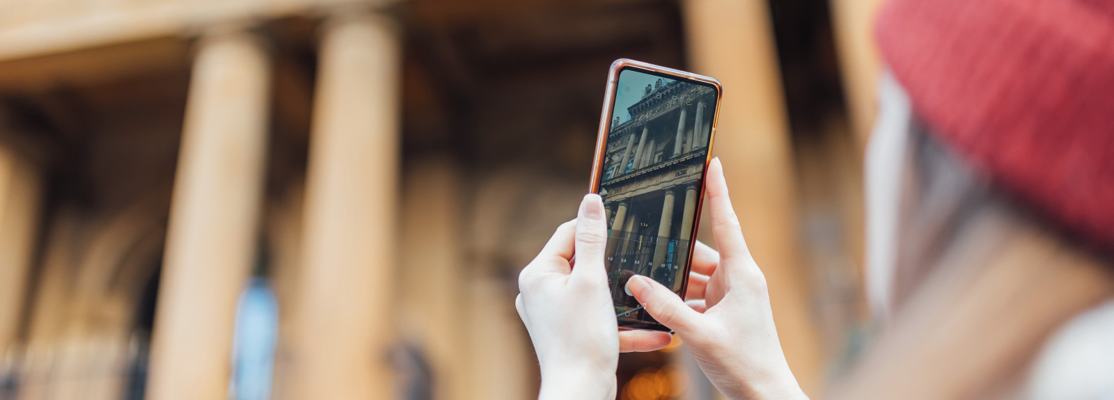 Student takes picture of the Merchant Hotel on their phone